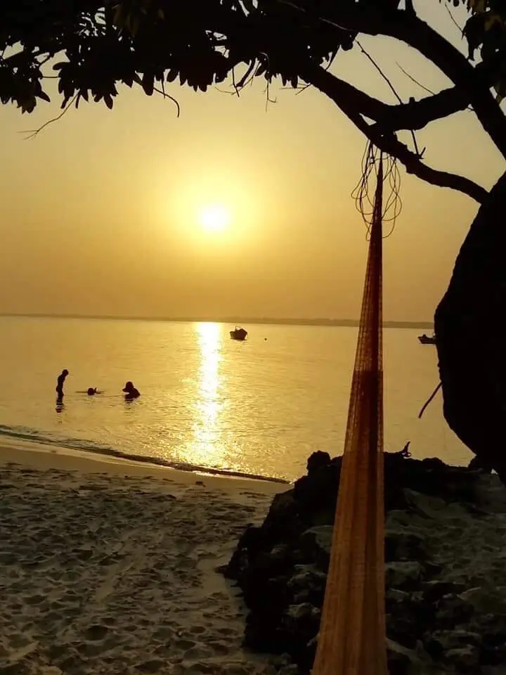 Wading at sunset with fishing nets